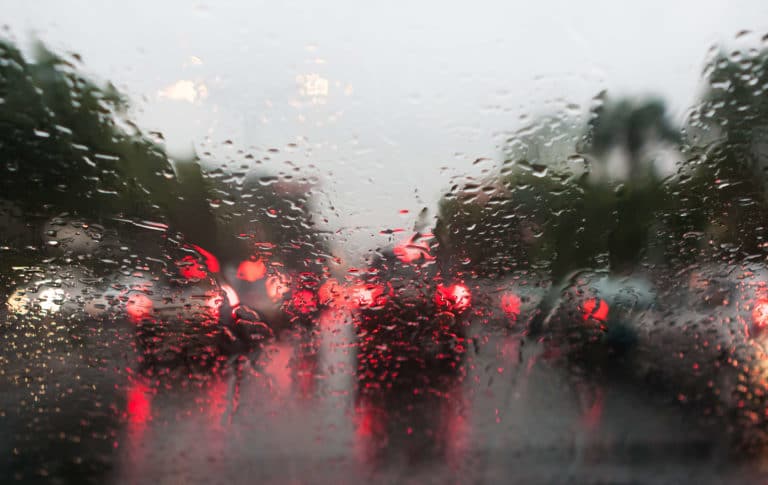 car taillights in traffic through rain
